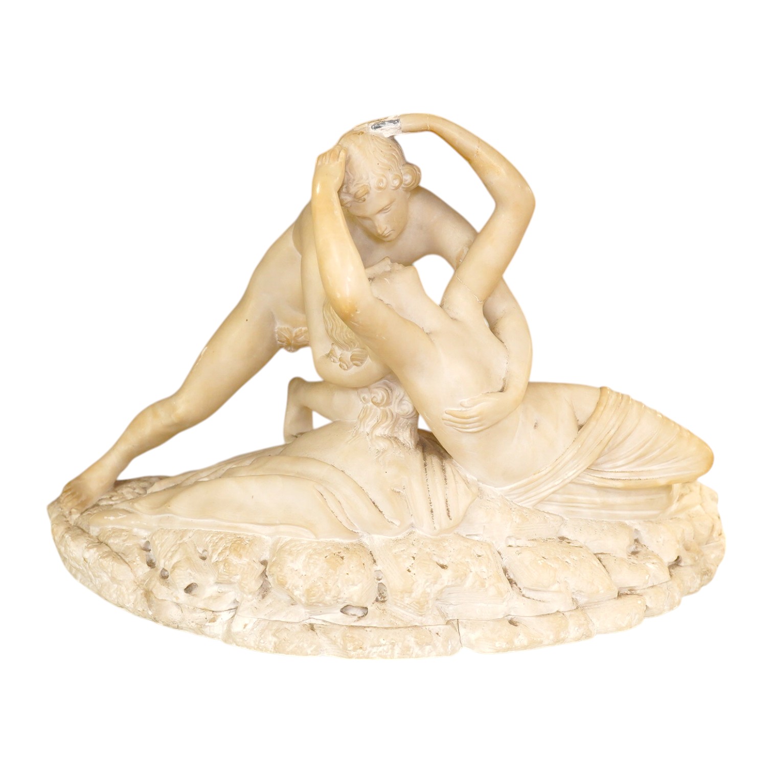 An alabaster figural carving of Cupid and Psyche, 28cm high, 45cm wide. Condition - poor to fair, some damage particularly to her hand, Cupid’s wings missing, etc.